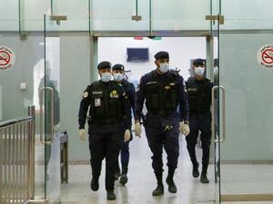 Kuwaiti policemen wearing protective masks wait at Sheikh Saad Airport in Kuwait City, on February 22, 2020, before transferring Kuwaitis arriving from Iran to a hospital to be tested for coronavirus. (AFP) Kuwaiti policemen wearing protective masks wait at Sheikh Saad Airport in Kuwait City, on February 22, 2020, before transferring Kuwaitis arriving from Iran to a hospital to be tested for coronavirus. (AFP)