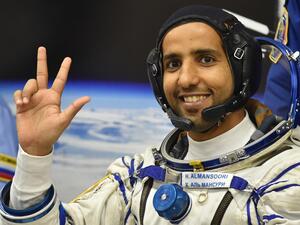 United Arab Emirates' astronaut Hazzaa al-Mansoori waves before boarding a Soyuz rocket to the International Space Station (ISS) at the Russian-leased Baikonur cosmodrome in Kazakhstan on 25 September 2019 (AFP)