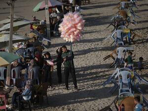 Palestinians gather at the beach during the Eid al-Fitr, the Muslim holiday which starts at the conclusion of the holy fasting month of Ramadan, in Gaza City on May 26, 2020 amid the coronavirus Covid-19 pandemic. Local authorities in the Hamas-run Palestinian enclave allowed mosques to reopen for Eid al-Fitr as social distancing procedures for the novel coronavirus are maintained while encouraging the elderly to perform prayers from home. MAHMUD HAMS / AFP