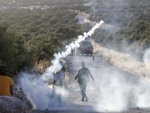A Palestinian demonstrator returns a tear gas canister during clashes with Israeli soldiers in the town of Tuqua in the Israeli-occupied West Bank on May 28, 2020. Musa Al SHAER / AFP