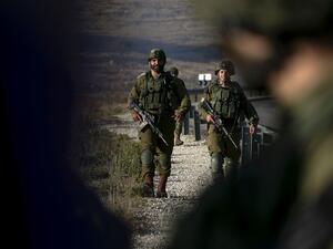 Israeli soldiers stand guard near the scene of a reported car-ramming attack north of the city of Ramallah in the Israeli-occupied West Bank, on May 29, 2020. A Palestinian man tried to ram a car into Israeli soldiers in the West Bank before being shot dead by troops, the Israeli army said in a statement. ABBAS MOMANI / AFP