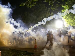 Tear gas rises above as protesters face off with police during a demonstration outside the White House over the death of George Floyd at the hands of Minneapolis Police in Washington, DC, on May 31, 2020. Thousands of National Guard troops patrolled major US cities after five consecutive nights of protests over racism and police brutality that boiled over into arson and looting, sending shock waves through the country. The death Monday of an unarmed black man, George Floyd, at the hands of police in Minneap