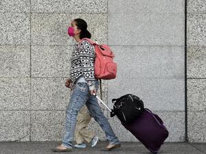 Passengers arrive on foot at Benito Juarez International Airport as employees block an access to the air terminal in demand of the payment of utilities, in Mexico City on June 1, 2020. (AFP)