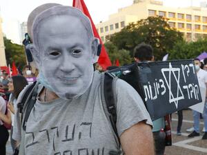 A protester wearing a mask of Israeli Prime Minister Benjamin Netanyahu during a demonstration in Tel Aviv's Rabin Square on June 6, 2020, to denounce Israel's plan to annex parts of the occupied West Bank. Israeli Prime Minister Benjamin Netanyahu has vowed to forge ahead with annexing settlements and the Jordan Valley, in line with the peace proposals unveiled in January by US President Donald Trump. The plan has been angrily rejected by the Palestinians, who say they were not consulted on proposals they 