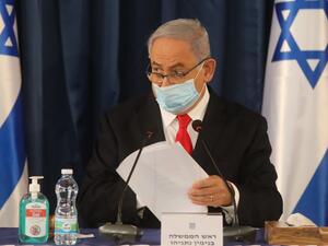 Israeli Prime Minister Benjamin Netanyahu, wearing a protective mask due to the COVID-19 pandemic, chairs the weekly cabinet meeting in Jerusalem on June 7, 2020. Netanyahu urged world powers to reimpose tough sanctions against Iran, vowing to curb Tehran's regional "aggression" hours after another deadly strike on pro-Iranian fighters in Syria. Menahem KAHANA / AFP