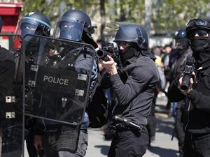In this file photo taken on April 20, 2019 A police officer points a 40-millimetre rubber defensive bullet launcher LBD (LBD 40) during clashes at the Place de la Republique during an anti-government demonstration called by the 'Yellow Vests' (gilets jaunes) movement for the 23rd consecutive Saturday, on April 20, 2019 in Paris. The 2019 report of the General Inspectorate of the National Police (IGPN) notably publishes the number of dead (19) and seriously injured (117) during police interventions and revie