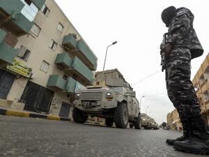 A member of security forces affiliated with the Libyan Government of National Accord (GNA)'s Interior Ministry stands as a security patrol advances in the town of Tarhuna, about 65 kilometres southeast of the capital Tripoli on June 11, 2020. Mahmud TURKIA / AFP