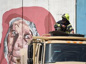 A firefighter from the government emergency committee sits on the rooftop of a vehicle before spraying disinfectant on a street as a preventive measure against the spread of COVID-19 coronavirus, in Kabul June 18, 2020. Early optimism that South Asia might have dodged the worst ravages of the coronavirus pandemic has disappeared as soaring infection rates turn the densely populated region into a global hot spot. After several months trailing the US and western Europe, cases of COVID-19 are surging across So