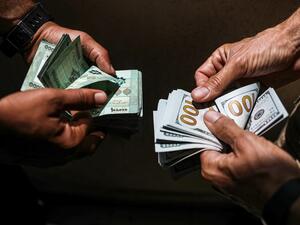 People exchange Lebanese pound and US dollar notes on the black market in Lebanon's capital Beirut on June 18, 2020. JOSEPH EID / AFP People exchange Lebanese pound and US dollar notes on the black market in Lebanon's capital Beirut on June 18, 2020. JOSEPH EID / AFP