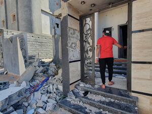 A libyan youth checks a damaged building entrance in the Salaheddin district south of the capital Tripoli, on June 21, 2020, as some residents return to the area after it has been demined. Since 2015, a power struggle has pitted the Tripoli-based Government of National Accord (GNA) against strongman Khalifa Haftar. (Mahmud TURKIA / AFP) A libyan youth checks a damaged building entrance in the Salaheddin district south of the capital Tripoli, on June 21, 2020, as some residents return to the area after it has been demined. Since 2015, a power struggle has pitted the Tripoli-based Government of National Accord (GNA) against strongman Khalifa Haftar. (Mahmud TURKIA / AFP)
