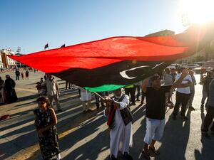 An elderly man waves a Libyan national flag during a demonstration in the Martyrs' Square in the centre of the Libyan capital Tripoli, currently held by the UN-recognised Government of National Accord (GNA), on June 21, 2020. The GNA on June 21 denounced Egypt's warning of military intervention in Libya, labelling it a "declaration of war", after the Egyptian President warned that if pro-GNA forces advanced on the strategic city of Sirte -- some 450 kilometres (280 miles) east of Tripoli -- it could provoke