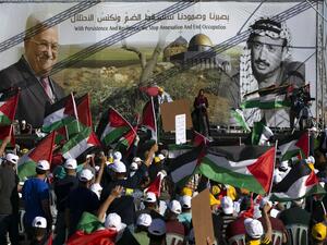 Palestinians wave flags during a big rally called by Palestinian Authority's Fatah party to protest against Israel's plan to annex parts of the occupied West Bank, in Jericho on June 22, 2020. Israel intends to annex West Bank settlements and the Jordan Valley, as proposed by US President Donald Trump, with initial steps slated to begin from July 1. ABBAS MOMANI / AFP