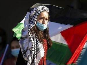 A Palestinian youth wearing a protective mask amid the COVID-19 pandemic takes part in a a rally against Israel's West Bank annexation plans, in the Jordan Valley village of Bardala in the occupied Palestinian territory, on June 27, 2020. JAAFAR ASHTIYEH / AFP