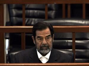 Ousted Iraqi President Saddam Hussein sits in court during the ‘Anfal’ genocide trial in Baghdad 06 December 2006. AFP