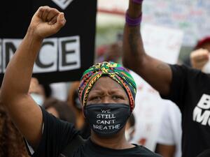 A woman raises her fist as protesters gathered for the March On Georgia, organized by NAACP, on June 15, 2020 in Downtown Atlanta, Georgia. The march comes in response to the police killing of Rayshard Brooks outside an Atlanta Wendy's restaurant on June 12. Dustin Chambers/Getty Images/AFP