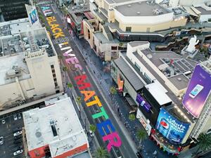 A photo taken with a drone shows people painting an 'All Black Lives Matter' mural on Hollywood Boulevard in Hollywood, California. (AFP/File)