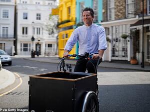 Reverend Pat, who worked as a curate before joining St Peter's in Notting Hill as a vicar in 2017,  travels his  London parish and beyond on a tricycle equipped with speakers. (AFP/File)