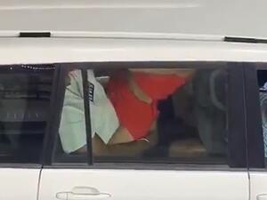 In the 18-second video which was posted on Twitter, a man in the back seat of a white car marked with the UN letters is seen being straddled by a woman in a red dress who is moving up and down. In the front of the car, a male passenger appears to be asleep (Twitter)