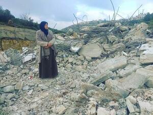 Mother of Palestinian_prisoner Asem al-Barghouti is standing on the rubble of his house which was demolished this night (Twitter)