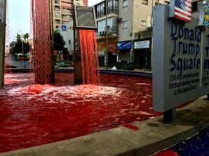 A fountain in Donald Trump Square in Petah Tikva is dyed red in a protest against West Bank annexation (screen capture via Twitter)