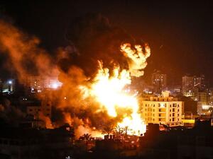 Fire and smoke below above buildings in Gaza City during reported Israeli strikes on March 25, 2019. (AFP)
