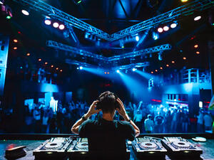 DJ with headphones at night club. (Shutterstock/ File Photo)