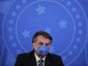Brazil's President Jair Bolsonaro wears a face mask during a press conference on the coronavirus pandemic COVID-19 at the Planalto Palace in Brasilia, Brazil on March 20, 2020. Brazil's government on Friday drastically downgraded its growth projections for 2020 by 2.1 percent to practically zero (0.02 percent) due to the coronavirus pandemic. Sergio LIMA / AFP