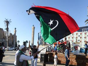 An elderly man waves a Libyan national flag during a demonstration in the Martyrs' Square in the centre of the Libyan capital Tripoli, currently held by the UN-recognised Government of National Accord (GNA), on June 21, 2020. The GNA on June 21 denounced Egypt's warning of military intervention in Libya, labelling it a "declaration of war", after the Egyptian President warned that if pro-GNA forces advanced on the strategic city of Sirte -- some 450 kilometres (280 miles) east of Tripoli -- it could provoke
