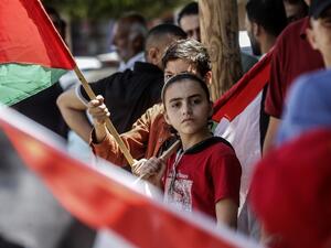Palestinian children carry national flags as they take part in a protest against Israel's plans to annex parts of the occupied West Bank, in Rafah in the southern Gaza Strip on June 27, 2020. Israel aims to begin a process of annexing West Bank settlements and the Jordan Valley from July 1. SAID KHATIB / AFP