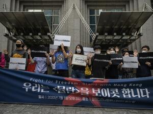 Protesters attend a rally against the release of the Disney movie 'Mulan' outside the company's office in Gangnam, in solidarity with Hong Kong's pro-democracy protests, in Seoul on July 1, 2020. Hong Kong police made the first arrest under Beijing's new national security law as the city greeted the anniversary of its handover to China with protests banned and its cherished freedoms looking increasingly fragile.  Ed JONES / AFP