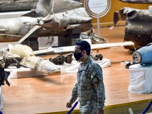 Royal Saudi Air Force Colonel Turki bin Saleh al-Malki walks past alleged Iranian weapons seized by Saudi forces from Yemen's Huthi rebels, ahead of a press conference at the Armed Forces Oficers club in Saudi Arabia's capital Riyadh on July 2, 2020, after air strikes on the rebel-held Yemeni capital. FAYEZ NURELDINE / AFP