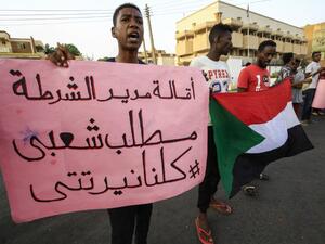 A demonstrator stands with a sign reading in Arabic "sacking the chief of police is a popular demand #WeAreAllNertiti", during a protest outside the Sudanese Professionals Association in the Garden City district of Sudan's capital Khartoum on July 4, 2020, in solidarity with the people of the Nertiti region of Central Darfur province in the country's southwest. ASHRAF SHAZLY / AFP