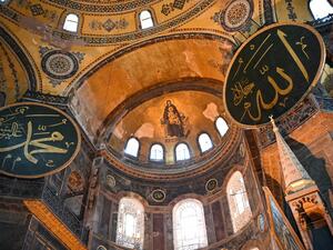 This file photograph taken on July 2, 2020, shows the Virgin Mary and child fresco and a calligraphic Roundels with Arabic letters bearing the name of Allah and other Muslim prophets hanging on the dome of The Hagia Sophia Museum in Istanbul. (AFP/File)