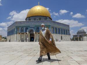 A Palestinian man walks outside the Dome of the Rock Mosque in Jerusalem's al-Aqsa compound amid the COVID-19 pandemic, on July 9, 2020. AHMAD GHARABLI / AFP