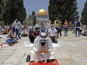 Palestinian Muslims perform the Friday prayer outside the Dome of the Rock Mosque, in Jerusalem's Al-Aqsa mosques compound, amid the novel coronavirus pandemic crisis on July 10, 2020. Ahmad GHARABLI / AFP