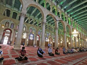 In this file photo taken on May 15, 2020, Syrian Muslims wearing face masks attend the Friday prayer at the Umayyad Mosque in Damascus, a temple of Jupiter transformed into a church in the 4th century, then into a mosque in the 7th, following the authorities' decision to allow prayers on Fridays in disinfected mosques with strict social distancing and protection measures to limit the spread of the coronavirus COVID-19 pandemic. Istanbul's iconic Hagia Sophia is to reopen for Muslim worship as a mosque after