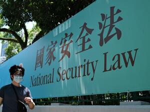 A man walks past a government public notice banner for the National Security Law in Hong Kong on July 15, 2020. Anthony WALLACE / AFP