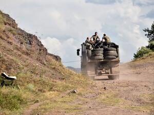 Armenian servicemen transport used tyres in the back of a truck to fortify their positions on the Armenian-Azerbaijani border near the village of Movses on July 15, 2020. Defence officials in Armenia and Azerbaijan said fighting on their border subsided on July 15, 2020 after several days of deadly clashes raised fears of a major flare-up. At least 16 people on both sides were killed in three days of shelling that started Sunday between the ex-Soviet republics, which have been locked for decades in a confli