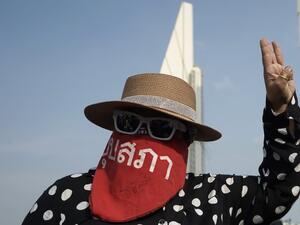 A protester makes the three-fingered Hunger Games salute while taking part in an anti-government demonstration in Bangkok on July 18, 2020. Scuffles broke out as thousands of mainly young and black-clad Thai protesters converged on July 18 at Bangkok's Democracy Monument, in the city's rowdiest anti-government protest in years. Aidan JONES / AFP