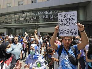 Lebanese activists demosntrate along with former employees of the American University Medical Center outside the hospital in the capital Beirut, on July 20, 2020. (JOSEPH EID / AFP)