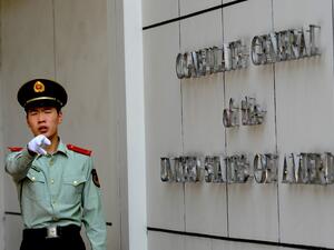 This file photo taken on September 18, 2012 shows a Chinese paramilitary policeman gesturing to photographers at the entrance to the US consulate in Chengdu, southwest China's Sichuan province. China said on July 24, 2020 it had revoked the license for the US consulate in the southwestern city of Chengdu, in retaliation for the closure of China's Houston consulate earlier this week. GOH Chai Hin / AFP