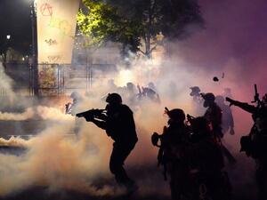 Federal officers deploy tear gas and less-lethal munitions while dispersing a crowd of about a thousand protesters in front of the Mark O. Hatfield U.S. Courthouse on Thursday, July 24, 2020 in Portland, Oregon. Protesters continued to clash with federal officers Friday morning as President Trump announced plans to deploy similar federal forces to other U.S. cities. Nathan Howard/Getty Images/AFP