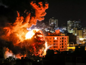 Fire and smoke billow above buildings in Gaza City during reported Israeli strikes on March 25, 2019. (Mahmud Hams / AFP)