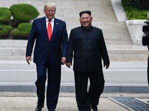 North Korea's leader Kim Jong Un walks with US President Donald Trump north of the Military Demarcation Line. (File Photo | AFP)