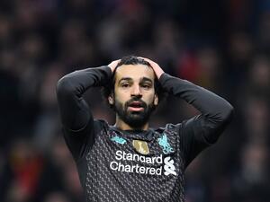 The Egyptian forward says he just wants to "enjoy the moment" after adding the Premier League to his ever-growing haul of major trophies (Photo: AFP)