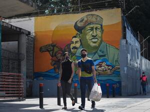 People wearing protective masks walks past a mural depicting Venezuela's late President Hugo Chavez, in downtown Caracas on July 28, 2020, after the government intensified a nationwide lockdown as a preventive measure against the spread of COVID-19. Federico PARRA / AFP People wearing protective masks walks past a mural depicting Venezuela's late President Hugo Chavez, in downtown Caracas on July 28, 2020, after the government intensified a nationwide lockdown as a preventive measure against the spread of COVID-19. Federico PARRA / AFP