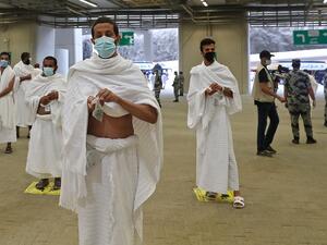 A picture taken on July 31, 2020 shows Muslim worshippers throwing pebbles as part of the symbolic al-A'qabah (stoning of the devil ritual) at the Jamarat Bridge during the Hajj pilgrimage in Mina, near Saudi Arabia's holy city of Mecca. STR / AFP