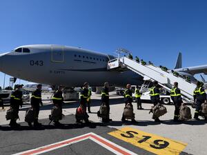 French Securite Civile (Civil Security) personnel board a Airbus A330, at Roissy airport, near Paris, on August 5, 2020. Bertrand GUAY / POOL / AFP