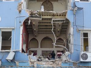 A Lebanese couple inspect the damage to their house in an area overlooking the destroyed Beirut port on August 5, 2020 in the aftermath of a massive explosion in the Lebanese capital. (JOSEPH EID / AFP)