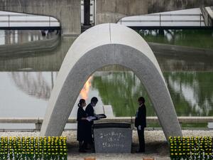 Hiroshima mayor Kazumi Matsui (R) and representatives of bereaved families take part in a ceremony at the Memorial Cenotaph during the 75th anniversary memorial service for atomic bomb victims at the Peace Memorial Park in Hiroshima on August 6, 2020. Japan on August 6, 2020 marked 75 years since the world's first atomic bomb attack, with the COVID-19 coronavirus pandemic forcing a scaling back of annual ceremonies to commemorate the victims. Philip FONG / AFP